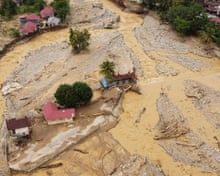 Families on rooftops, homes buried by mud: Asia floods show water is overtaking wind as main threat