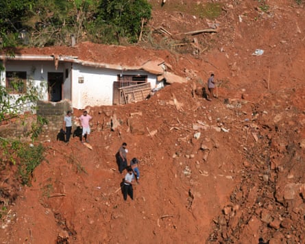 Families on rooftops, homes buried by mud: Asia floods show water is overtaking wind as main threat